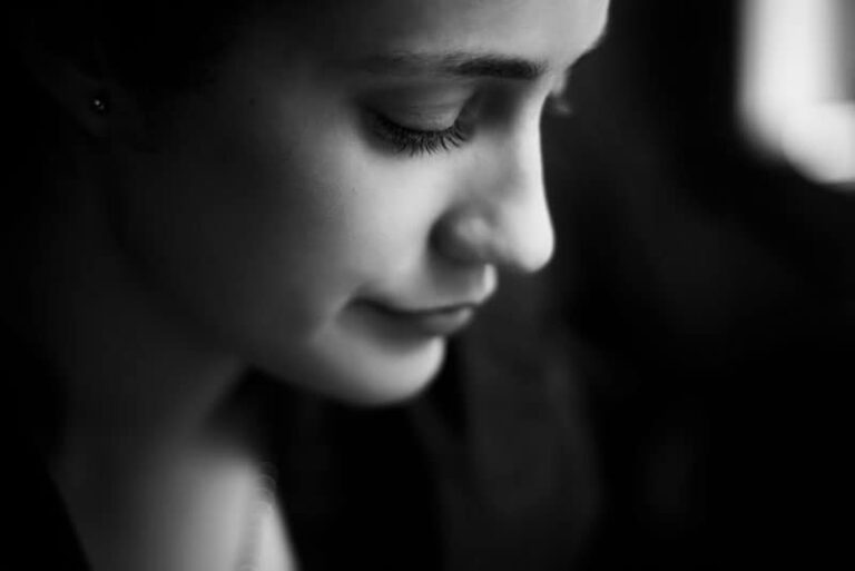 depressed woman standing in the dark