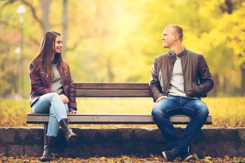 Young couple is sitting on a bench