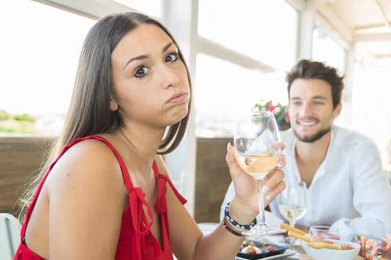 annoyed woman with man on the dinner