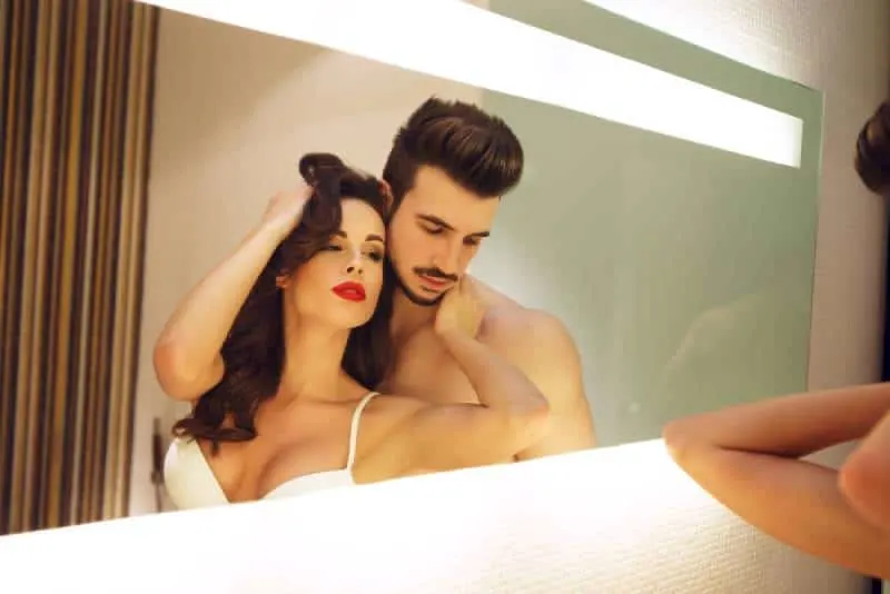 sexy lovers in front of mirror