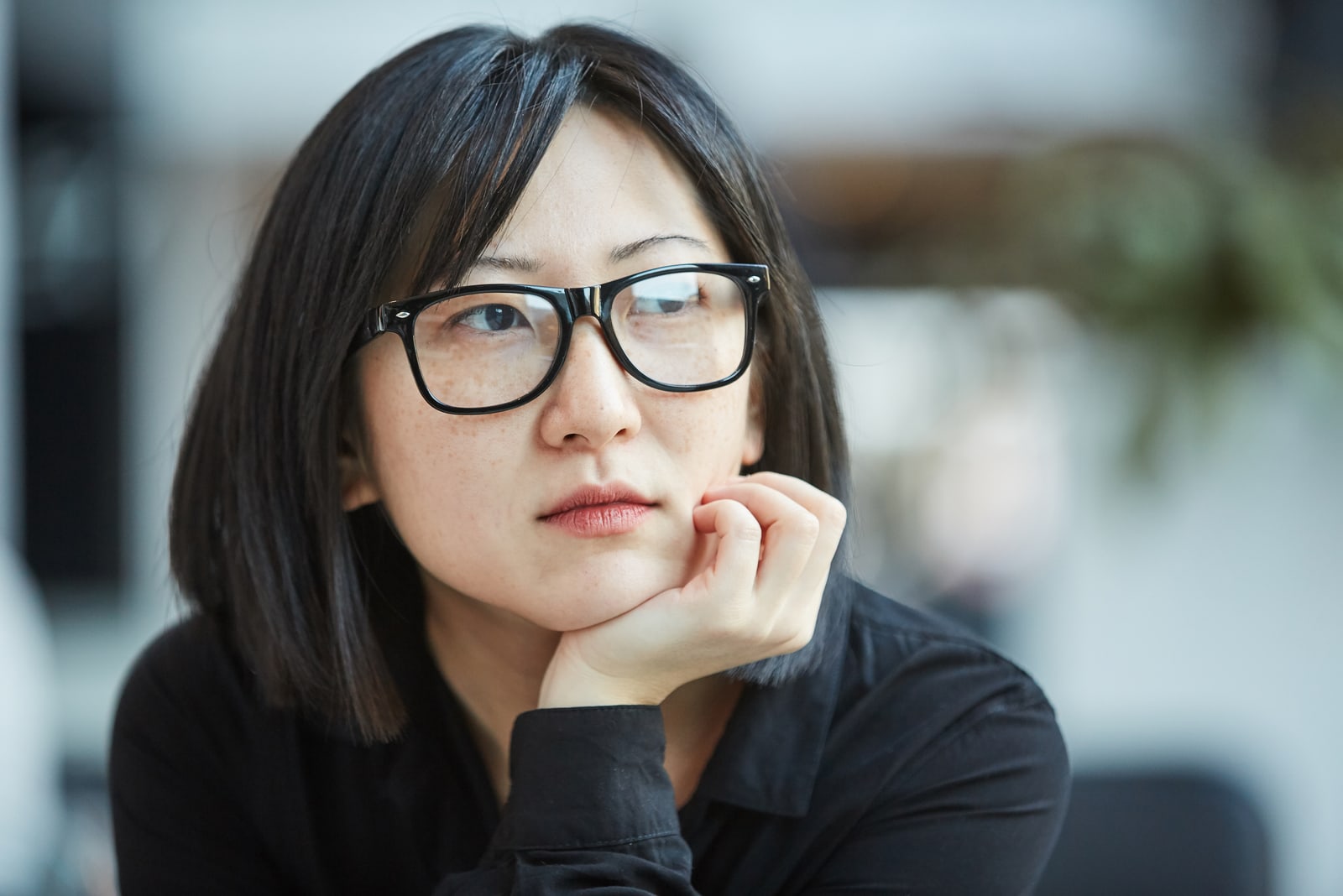 woman wearing stylish eyeglasses looking away