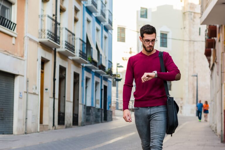 man wearing glasses looking at his watch
