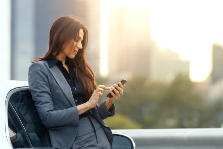 Business Woman Uses Smartphone