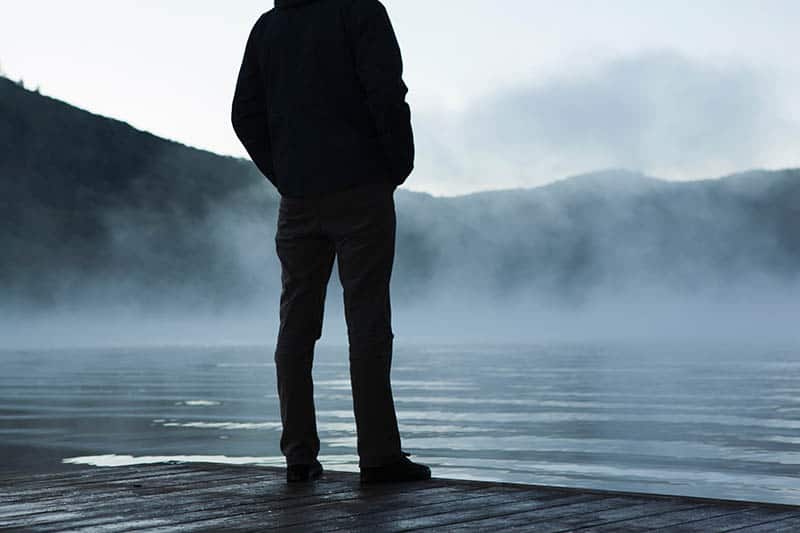 Man standing alone by the water