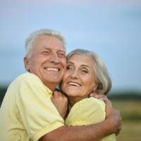 smiling grandparents hug