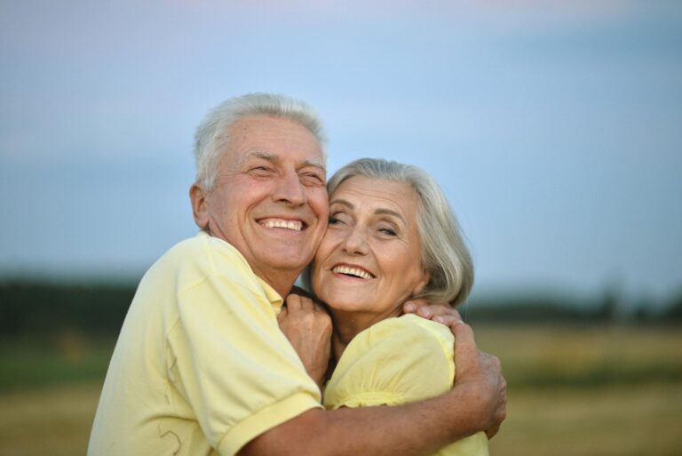 smiling grandparents hug