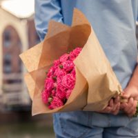 man holding flowers