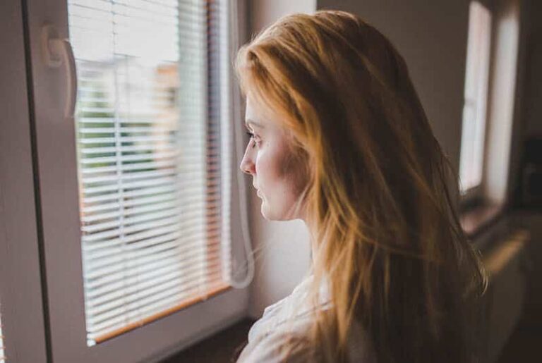 disappointed woman looking through the window