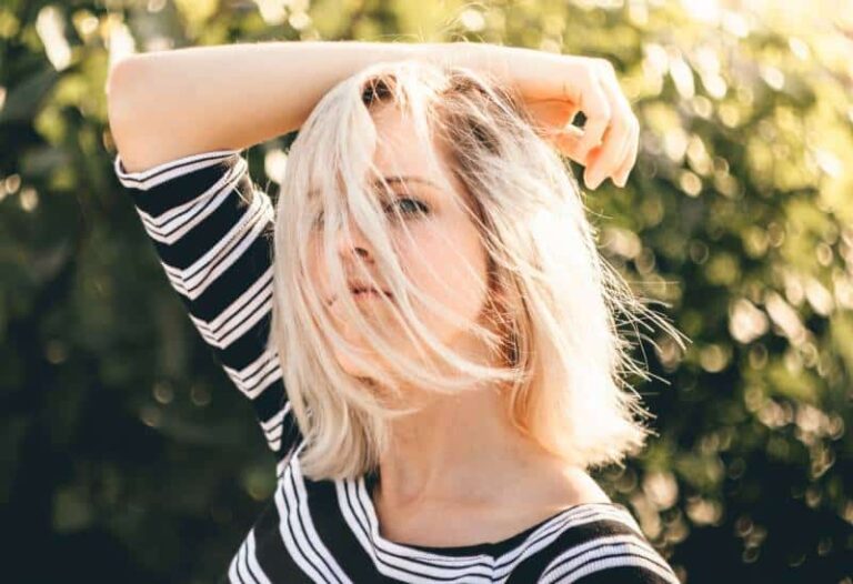 shallow focus photography of woman in black and white striped top