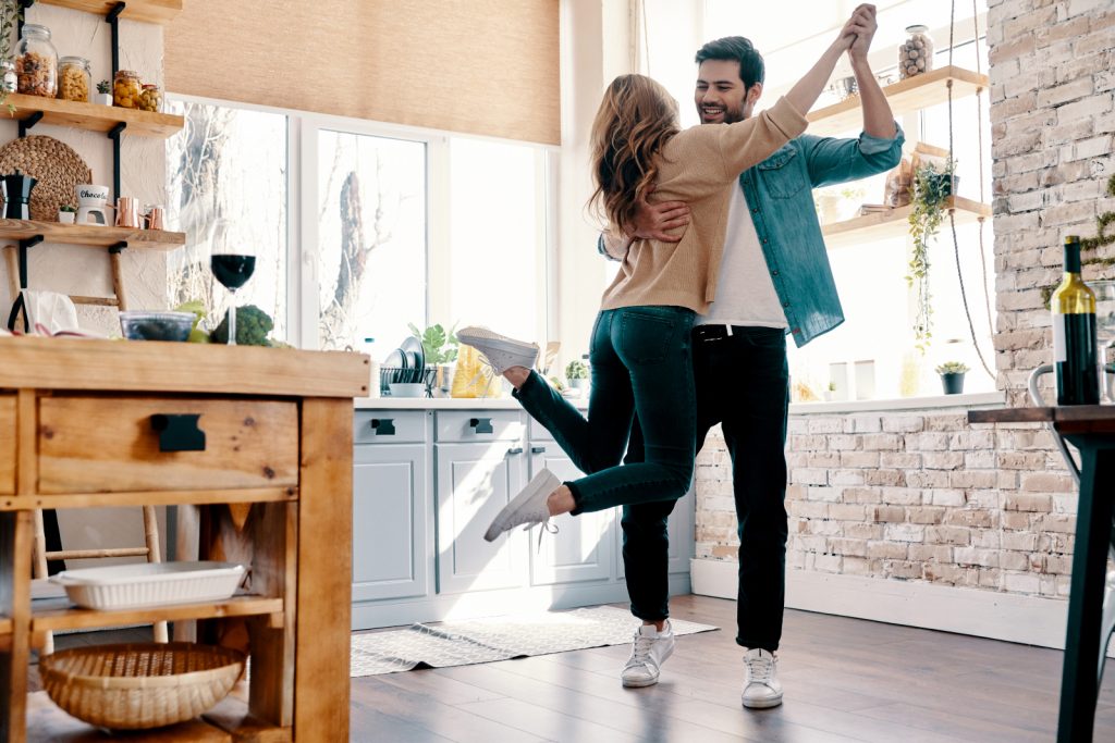 a couple dancing in the kitchen
