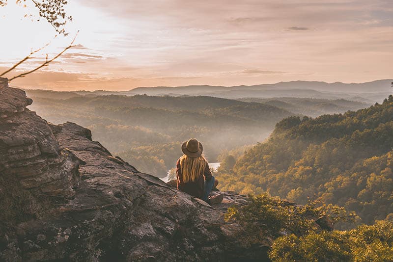 Girl at viewpoint watching the breathtaking landscape