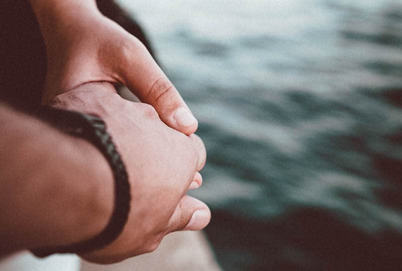 close up photo of couple holding hands