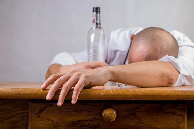 drunk man sleeping on table