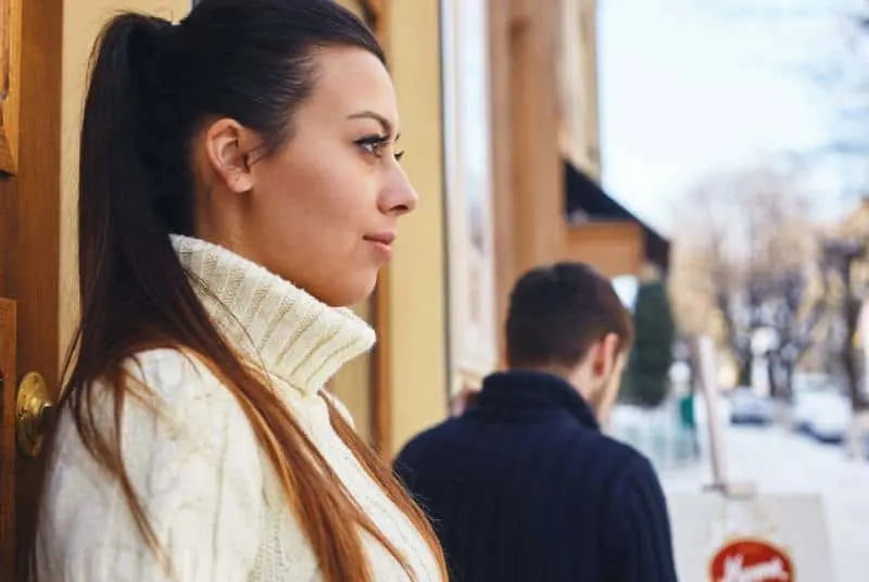 girl looking at boyfriend while leaving her