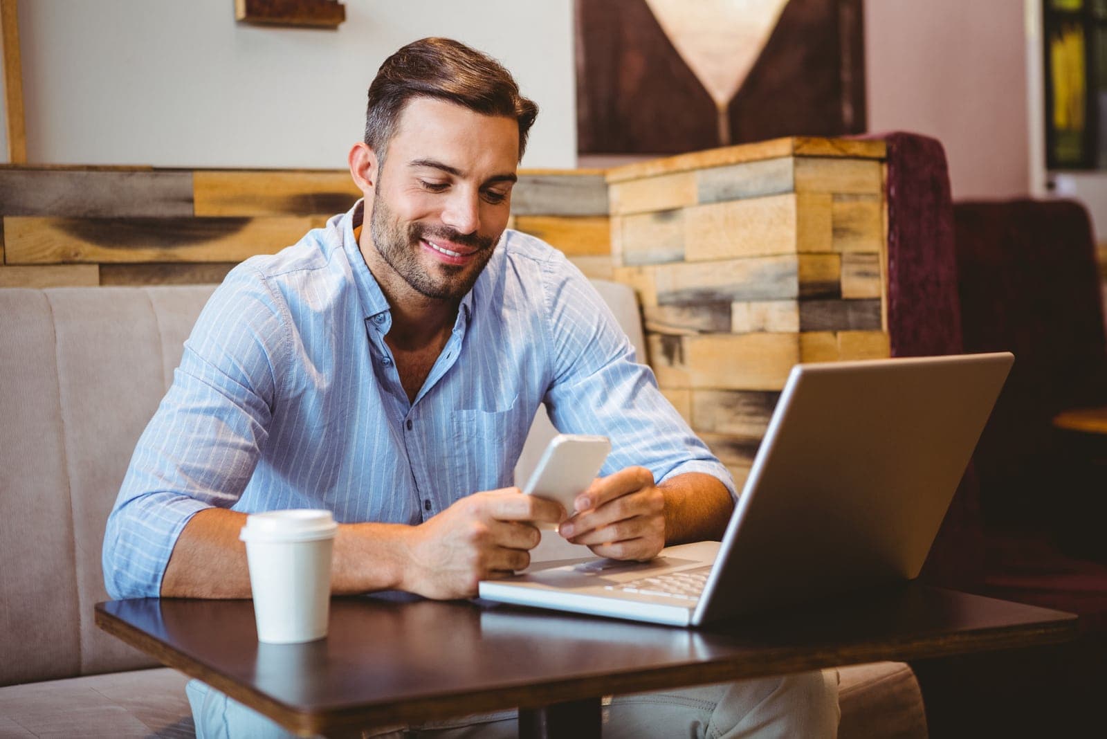 handsome smiling man texting