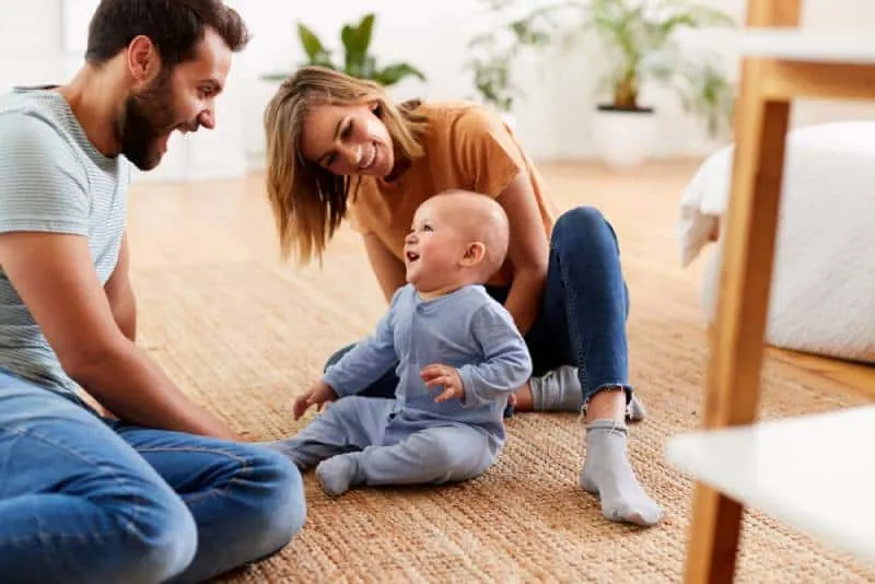parents playing with baby at home