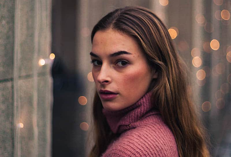 portrait of cute woman wearing rose sweatshirt