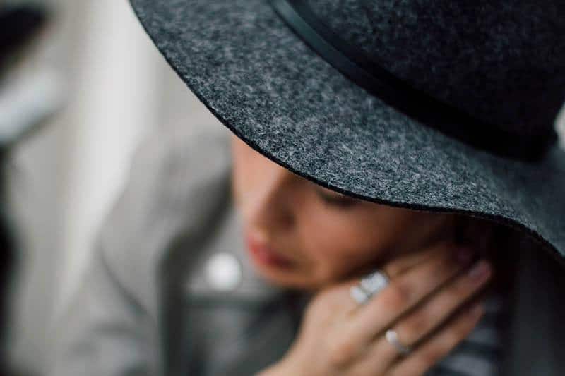 shallow focus of woman wearing black hat