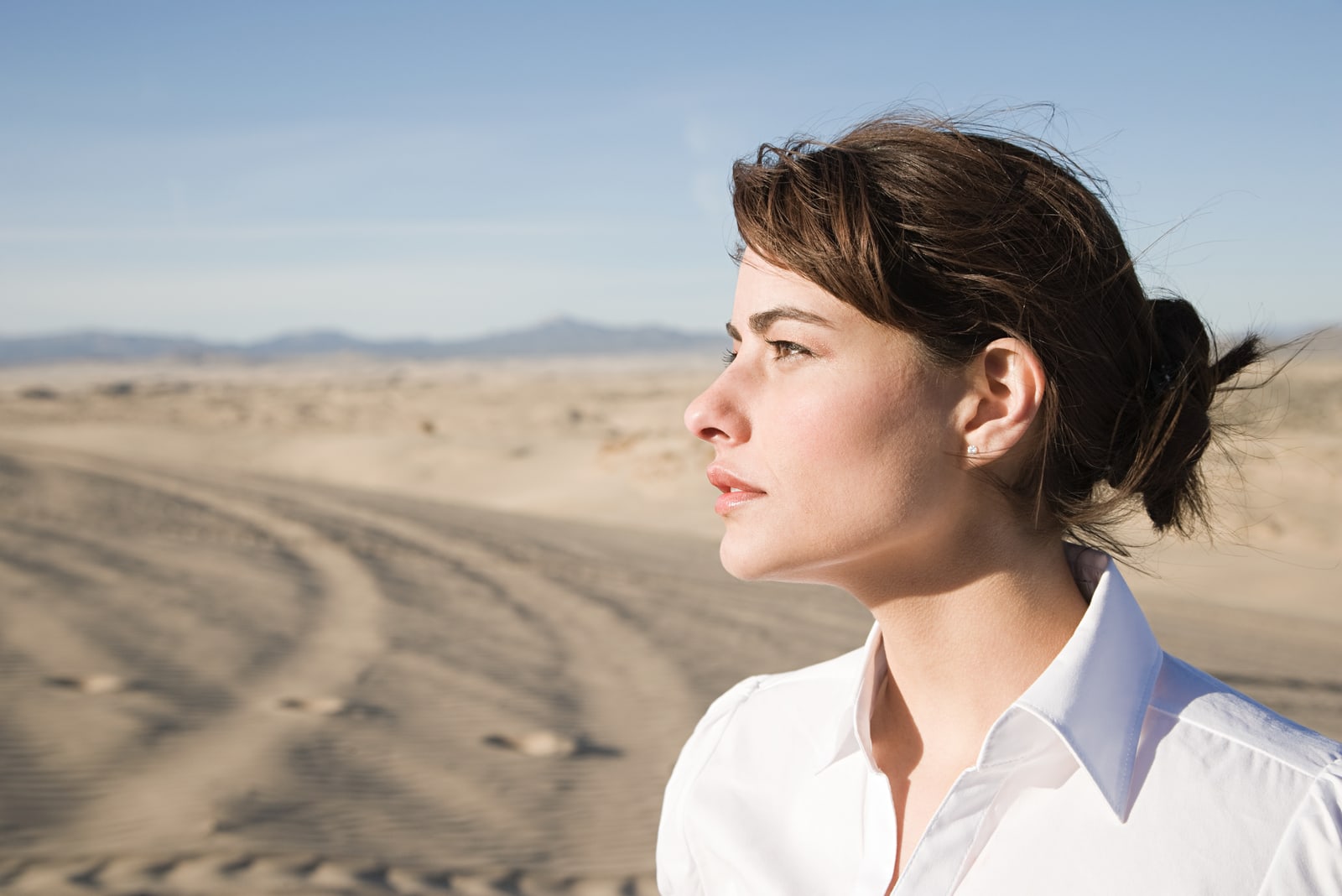 woman standing in desert alone