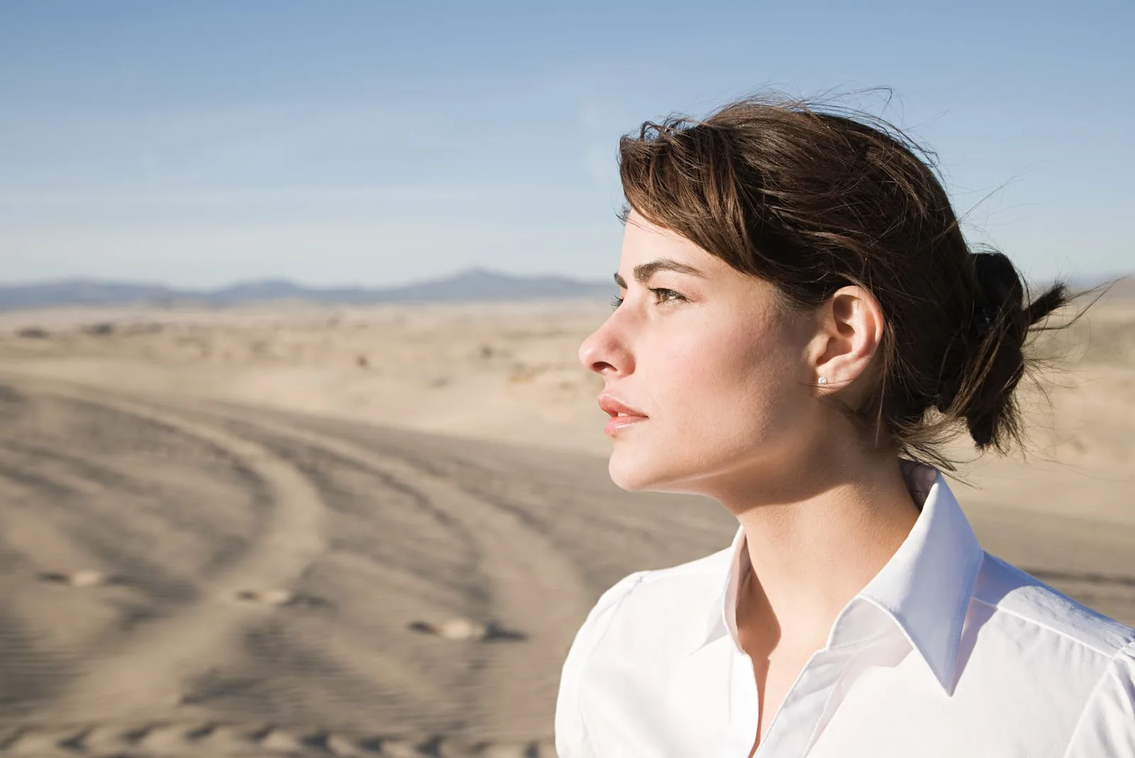 woman standing in desert alone