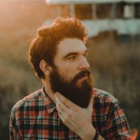 bearded man standing in nature