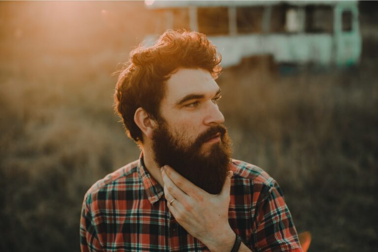 bearded man standing in nature