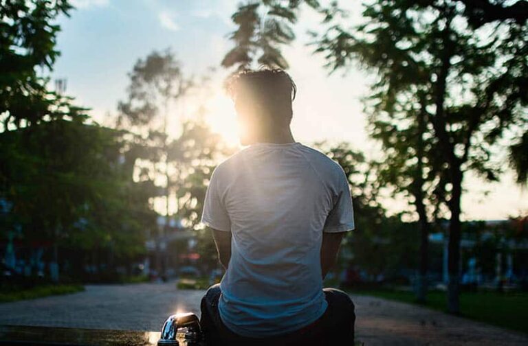 man sitting during sunset