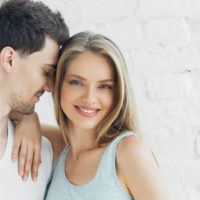 man in love standing with smiling woman