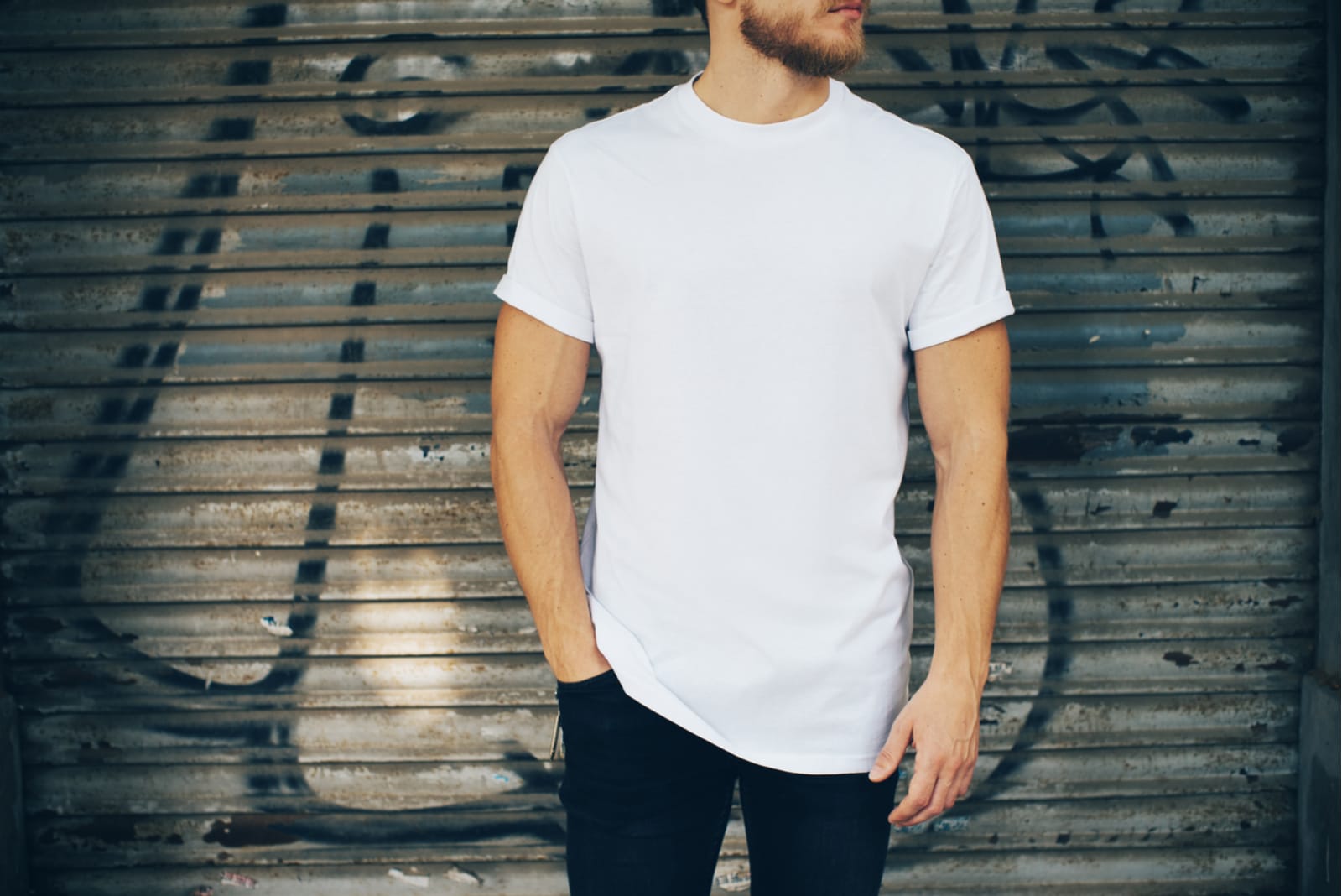 Young man wearing white blank t-shirt and blue jeans