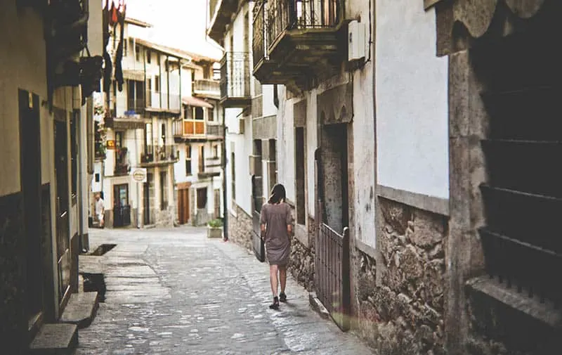 Woman walking through old city streets