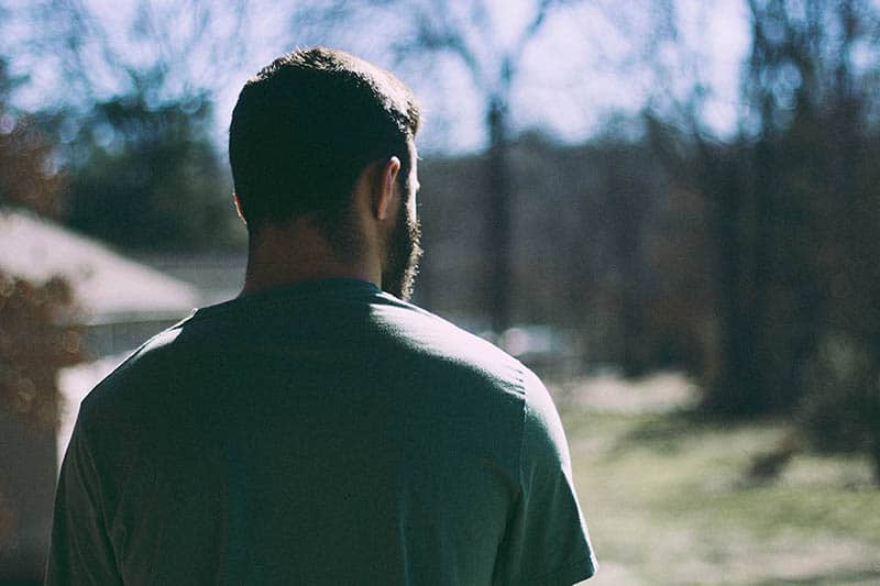 Man standing on terrace with his back turned