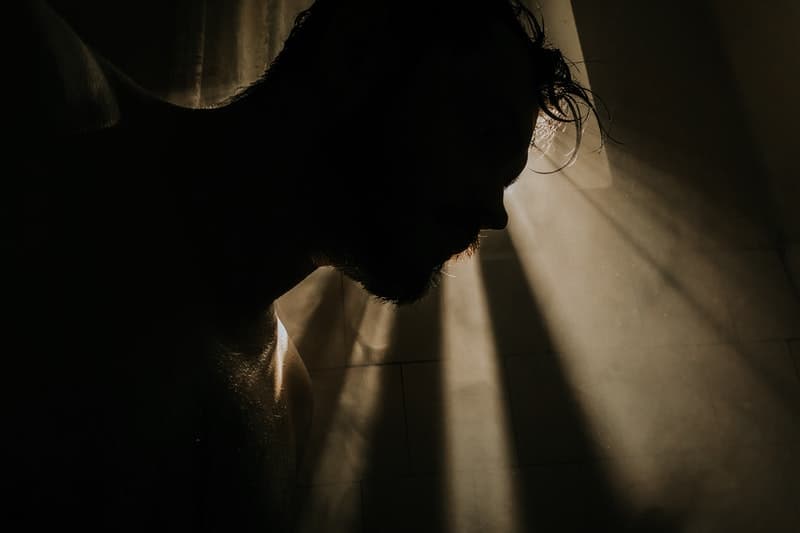 silhouette of man taking shower