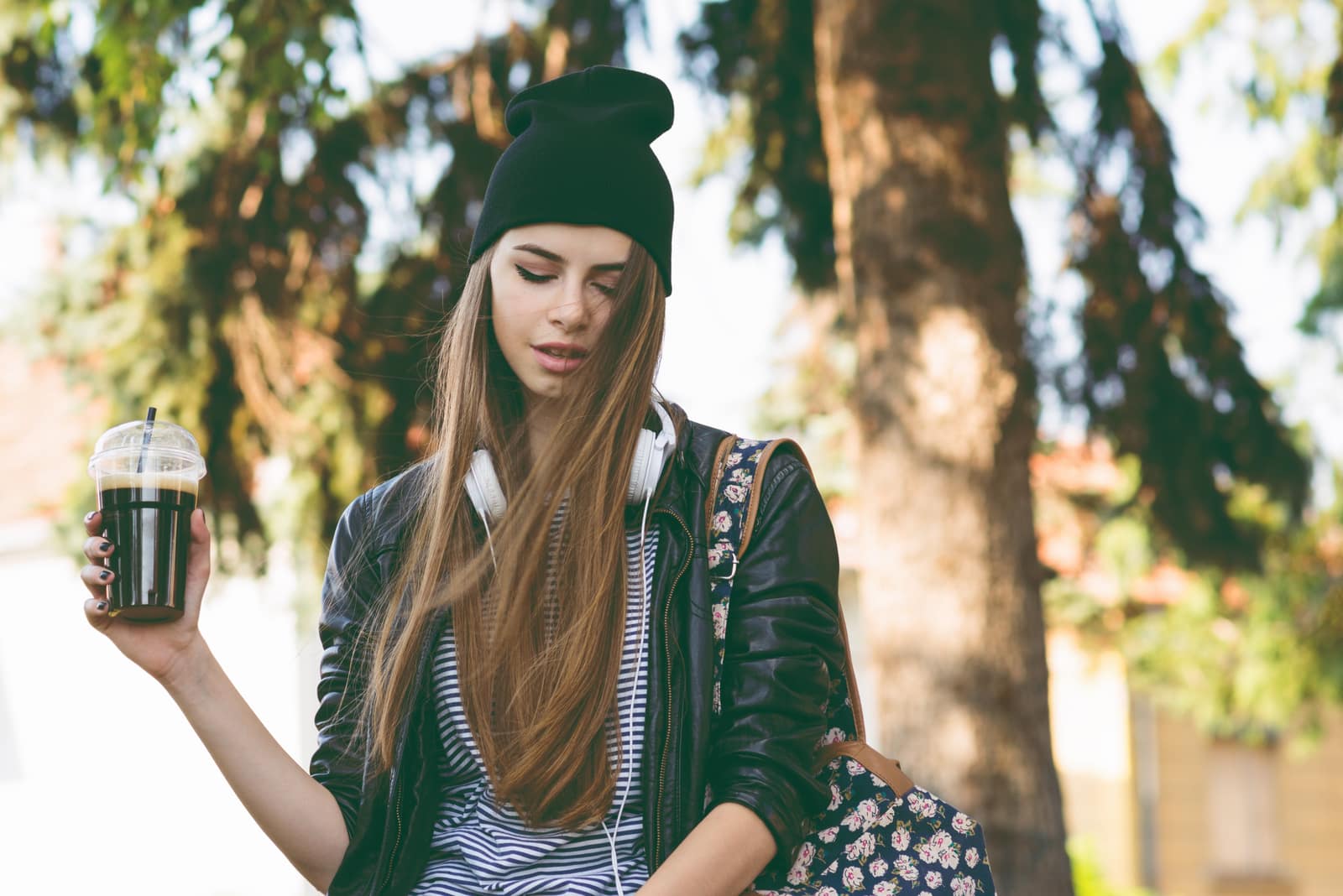 teenage hipster girl in autumn in park in beanie hat
