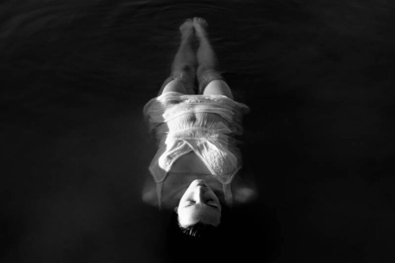 lonely woman laying on water