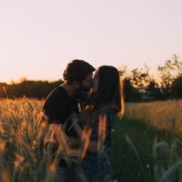 couple kissing in the field