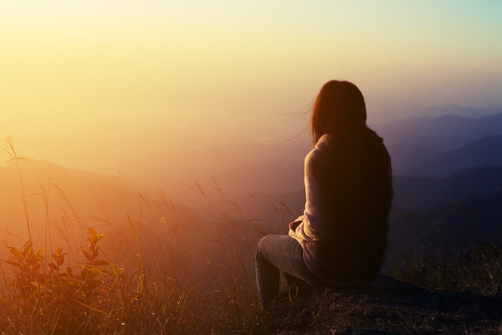 a woman sitting on a stone