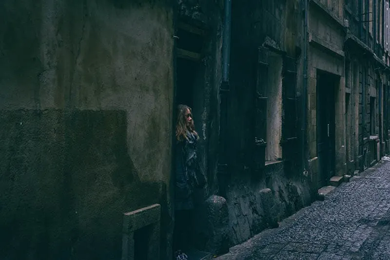 Girl standing on a doorway of a ruin