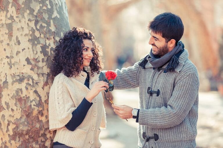 man giving a flower to the woman