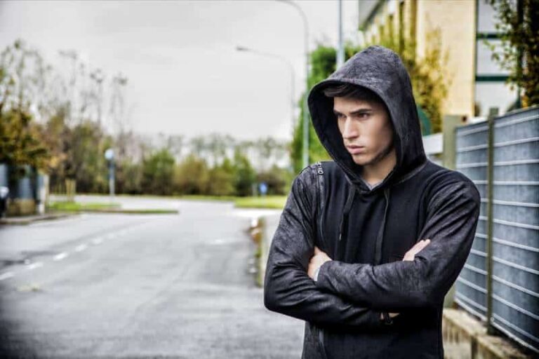 serious man with crossed hands outside