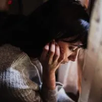 pensive woman with her head down