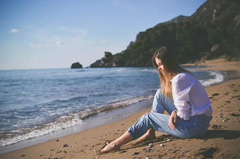 Girl sitting on beach 