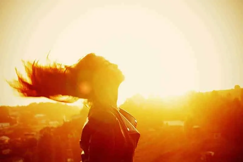 side view of woman standing during sunset