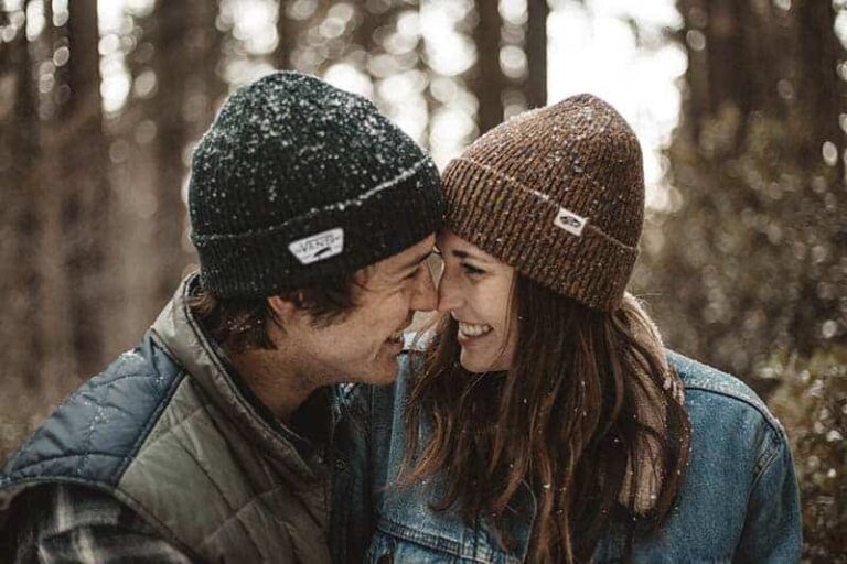 lovely couple laughing and looking each other between trees