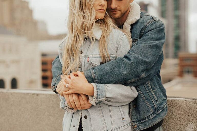 man hugging woman from back outside