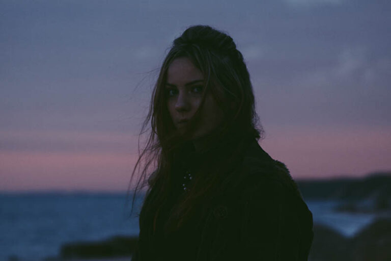 portrait of woman standing outside during evening