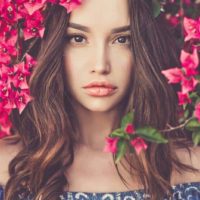 young brunette surrounded by flowers