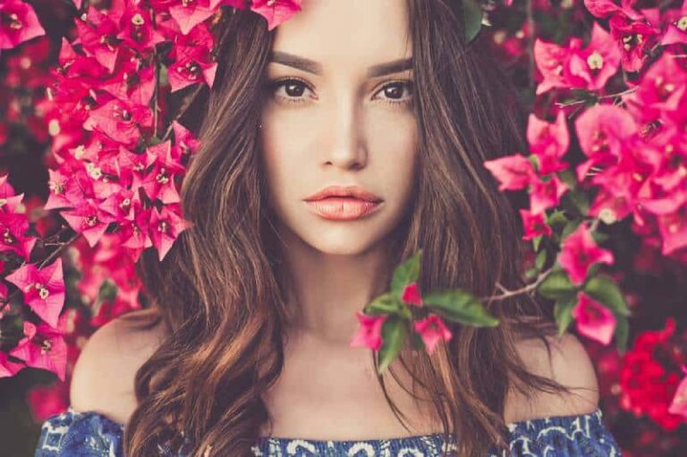 young brunette surrounded by flowers