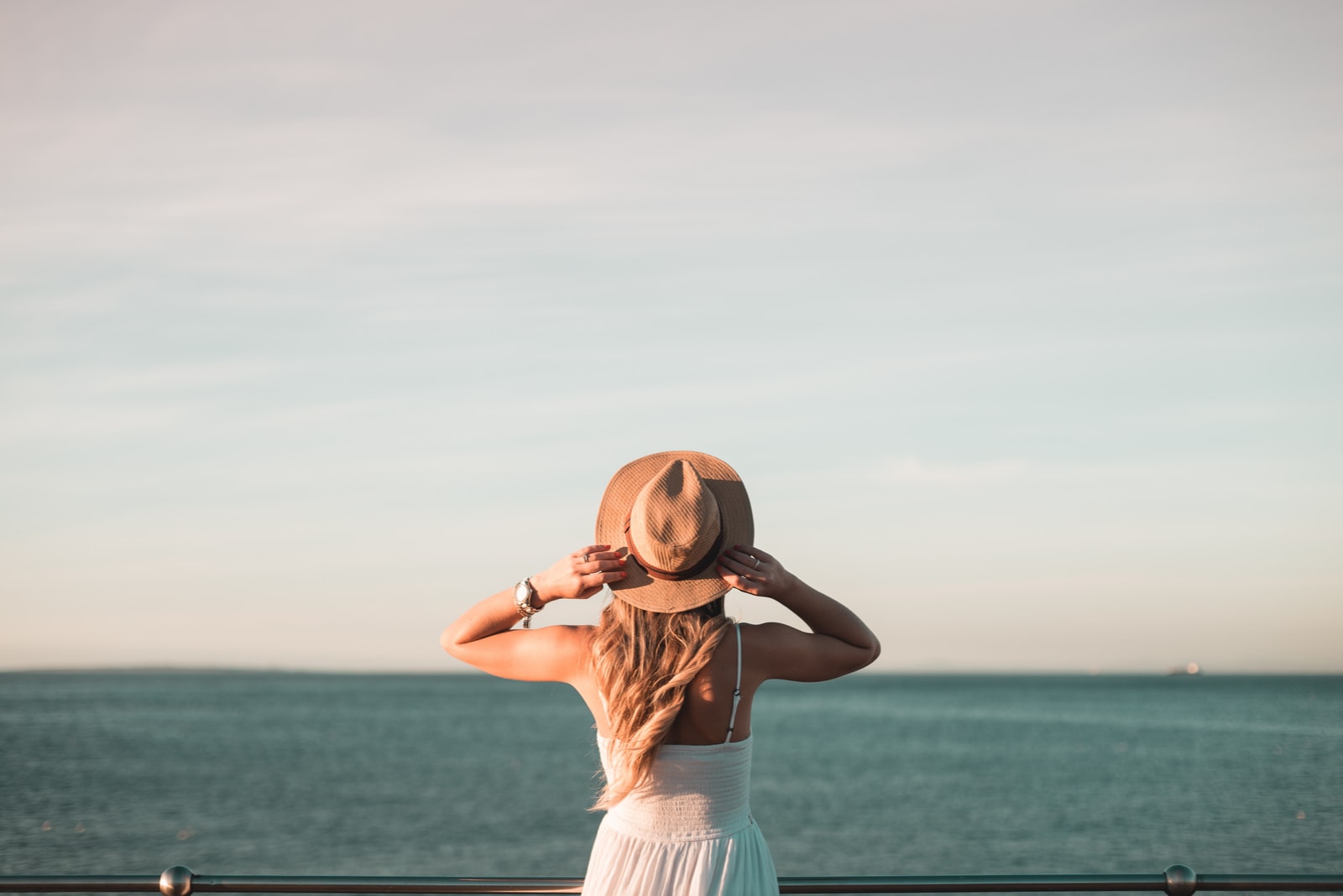 Woman standing alone watching ocean