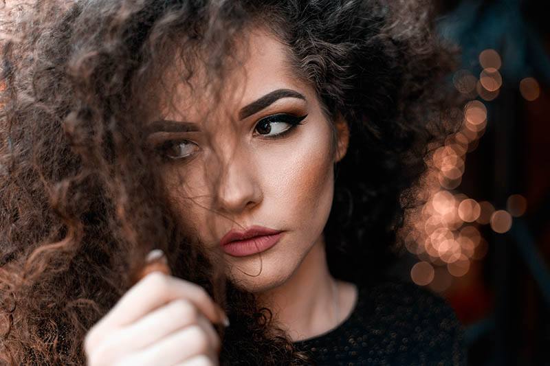 close up photo of woman with curly hair