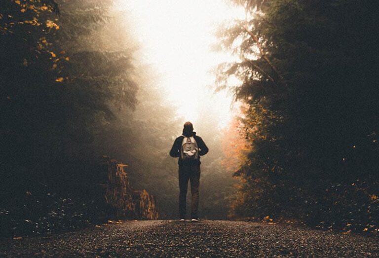 man with backpack in the woods